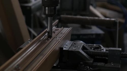 Drill Bores Hole in Metal Piece