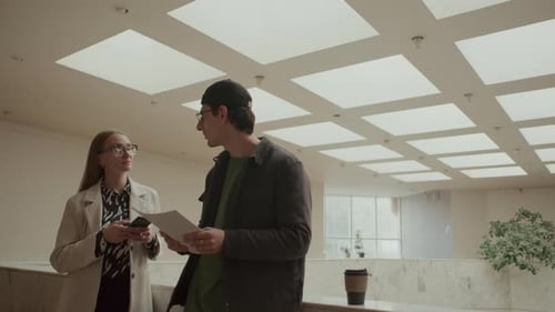 Two Colleagues Discussing Project in Modern Office Space