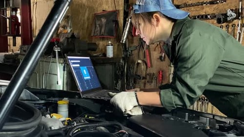 Young Female Mechanic Prepares for Computer Car Diagnostics