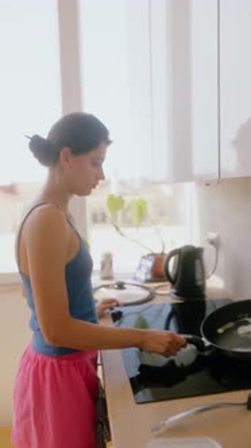 Woman Cooking Food in Kitchen at Home