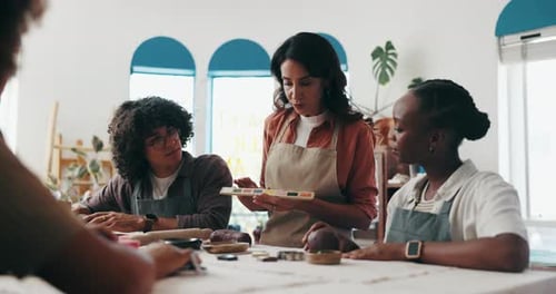 Pottery, palette and woman with people in workshop for skills with clay