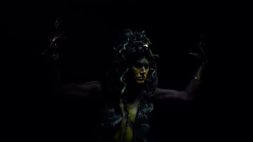 Woman in Snake Hair Rises Arms