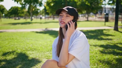 Calling Woman Sitting Grass Urban Park Closeup Relaxed Brunette Talking Phone