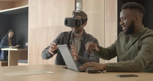 Engineers working with virtual reality headset in creative office