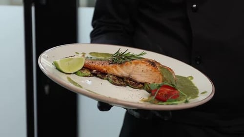 chef prepares a salmon dish in the kitchen. Close-up shots
