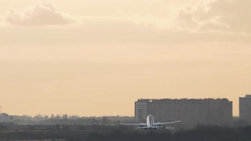 Airplane Takes Off Rear View Airfield at Sunset