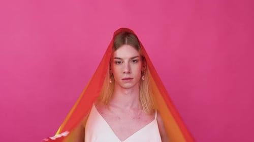 Beutiful Young Transgender Man Lifing Rainbow Flag From Her Head in the Air