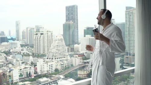 Man Dancing in Robe Listening to Music
