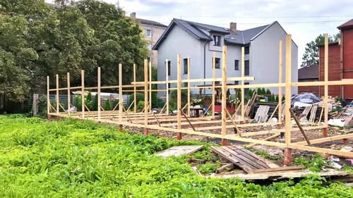 Construction Framework in Backyard with Green Grass
