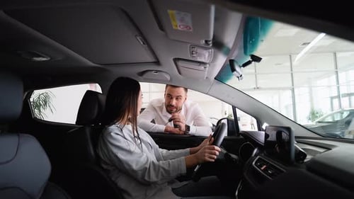 Car Dealer Giving New Car Key to Female Customer