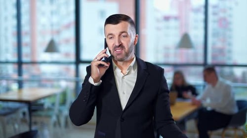 Confident young businessman have a phone call. Handsome office worker working with smartphone.