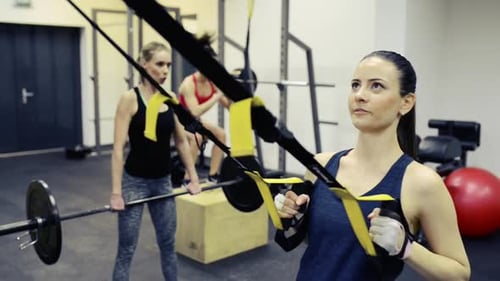 Women in Gym Working Out with Various Equipment