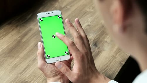 Man Using Smartphone with Green Screen for Chroma Key