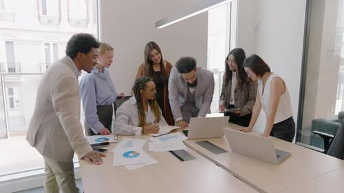 A Diverse Business Team Engaging in Collaborative Activities Within a Modern Office Space