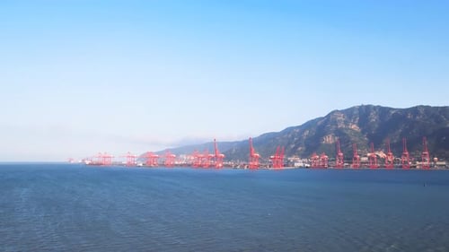 Bird's view of Cargo container transport ship and crane at sea port industrial district, silhouette
