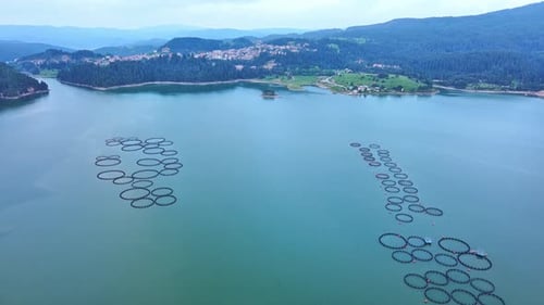 Fishing Cages for Breeding Fish in Lake in Mountain Valley of Rhodope Mountains Under Cloudy Sky