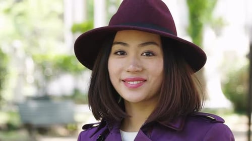 Stylish Woman Smiles in Urban Park Setting