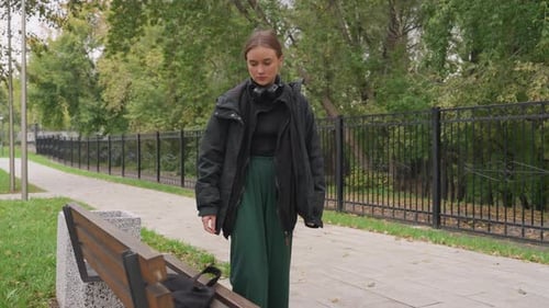 Contemplative Woman Resting Thoughtful Lady in Park Pensive Female Sitting Amidst Autumn Scenery