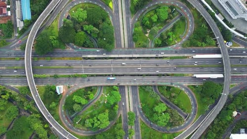A freeway with a large bridge over it and a city in the background