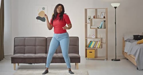 Energetic Woman Dancing at Home in Living Room