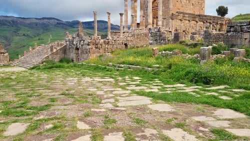 Revealing shot of Roman Severan temple and columns in archaeological site of Djemila Algeria on clou