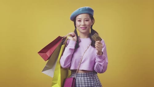 Female Shopper Dressed in Pink Sweater and Beret Happily Displaying Payment Confirmation After