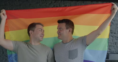 Couple Holding a Rainbow Flag