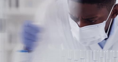 Lab Worker Uses Dropper for Scientific Experiment