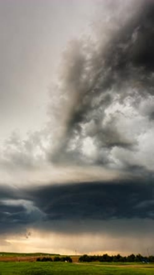 Dramatic Storm Clouds Over Lush Green Field