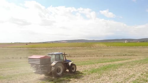Tractor Plowing Field on Sunny Day