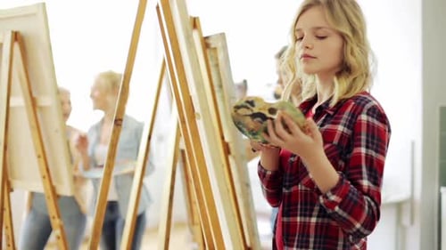 Art School, Creativity and People Concept - Group of Students with Easels