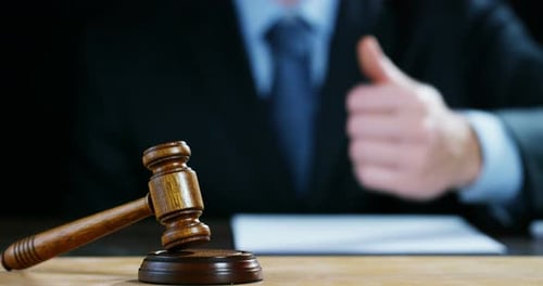 Gavel on Desk with Thumbs Up Approval