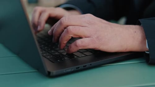 Close up Of Hands Typing On A Laptop