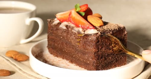 Delicious slice of chocolate cake with strawberries