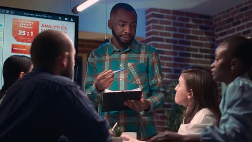 African American Business Coach Giving Presentation in Company Meeting