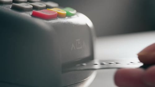 close-up of a female hand inserts a payment card into the terminal for online payments, The process