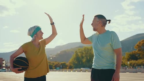 Mature Couple High Five After Basketball Game