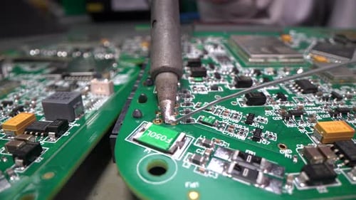 Engineer Soldering Printed Circuit Board