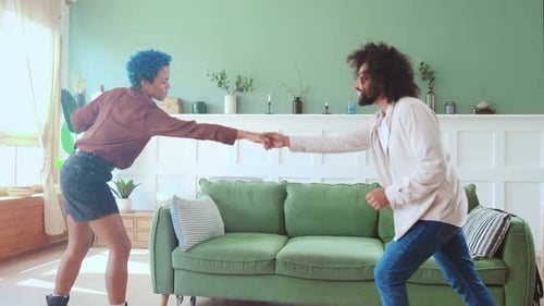 Adults Dancing Happily in Living Room
