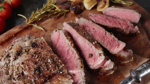 Delicious Sliced Steak Close Up on Wooden Board