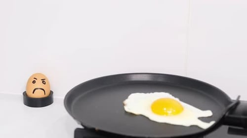 Fried Egg Next to a Frowning Egg