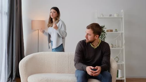 Couple Arguing in Brightly Lit Living Room