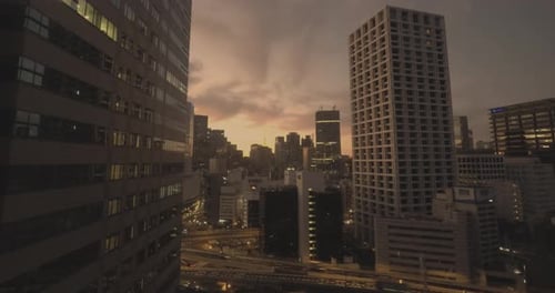 Timelapse of sunrise in Tokyo, Japan. Tokyo Tower between the buildings.