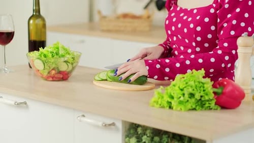 Woman Prepares a Fresh Salad in Bright Kitchen
