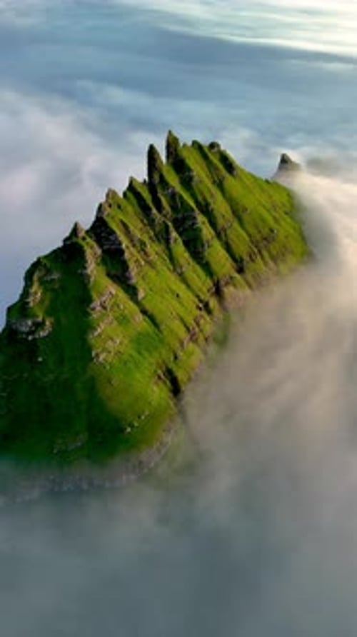 Majestic Drangarnir Cliff Rising Above Enveloping Fog in the Faroe Islands