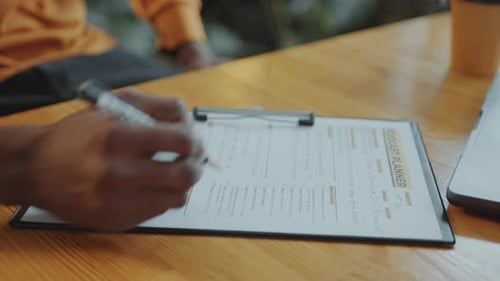 Hands of Podcast Presenter Proofreading Content Planner and Taking Notes