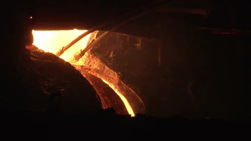 Molten Metal Flowing at a Smelting Facility at Night