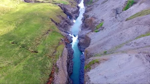 Aerial, reverse, drone shot over the basalt columns, the Jokulsa a bru river and the Studlagil Canyo