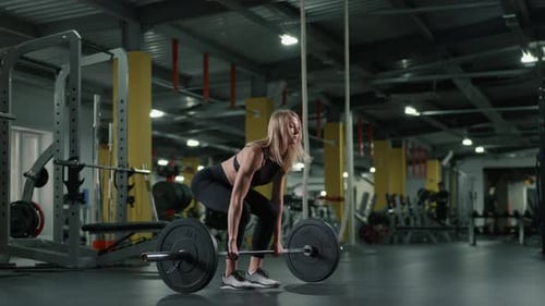 Caucasian Woman Lifting Heavy Weights with Her Arms