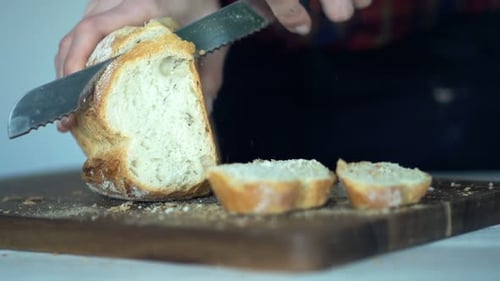 Closeup Shot Of Female Hands Slicing White Bread, Super Slow Motion 240fps